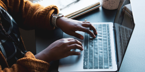 hands on laptop keyboard